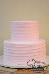 Two tier spoon with a light pink frosting. Simple and elegant &ndash; fresh flowers could be added.