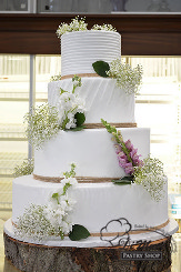 This four tier cream cake is beautifully garnished with Baby&rsquo;s-Breath that make the finishing
touches.