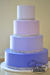 This four tier cream purple ombre cake is fun and festive for any occasion.