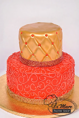 Red and gold two tier fondant cake