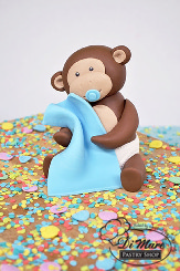 Money around with this two tier fondant baby shower cake, complete with fondant monkey topper