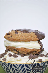 Cannoli chipwich- two delicious chocolate chip cookies filled with cannoli cream and garnished with chocolate chips.