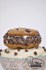 Cannoli chipwich- two delicious chocolate chip cookies filled with cannoli cream and garnished with chocolate chips.