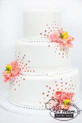 This beautiful three tier fondant cake has a pearl border, gold painted dots with gum paste flower accents.