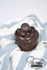 Black velvet cupcake with fudge filling and topping