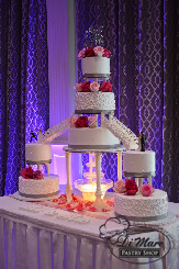An absolute statement piece! These cakes have scroll and smooth and swiss dots designs with silver ribbon and fresh flowers. Put together, these cakes create a delightful fantasy with a working water fountain, stairs and joyus cake toppers.