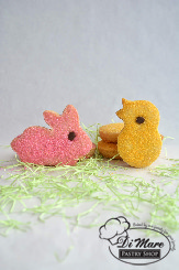 Small bite size cookies in the shape of bunnies and chicks topped with sanding sugar and a chocolate chip of an eye!