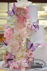 Silk butterflies beautifully emerge from this 3 tier whipped cream cake, creating a stunning cake.