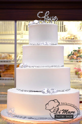 A simple, smooth, 4 tier wedding cake decorated with just the right amount of bling.