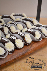 Football cannolis make a great treat for the dessert table at your football viewing.