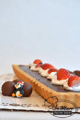 Chocolate and hazelnut come together in a creamy mix that fill this tart, topped with whipped cream and strawberries.