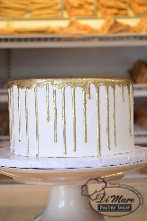 A simple smooth whipped cream topped with elegant gold dripping.