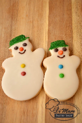 Sweet smiling snowman cookies iced and topped with M&M&rsquo;s.