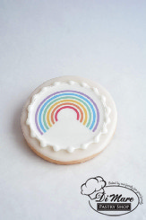 A simple and beautiful rainbow image tops this round iced cookie.