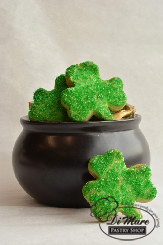 Small shortbread cookies covered with sanding sugar shaped as shamrocks.