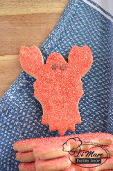 A bit of a twist on our daily catch of the day! Our cute Lobster cookies topped with sanding sugar and chocolate chips for eyes. A nautical delight.