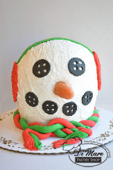 Miniature buttercream cake shaped as hot chocolate cups or an adorable reindeer. Too sweet to pass up!
