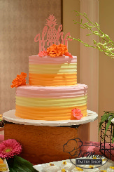 A beautiful two tier tri-color cake with and adorable Aloha! cake topper.