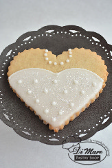An iced cookie in the shape of a bridal dress.