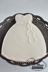A clever iced heart cookie decorated as the top of a  bridal gown.