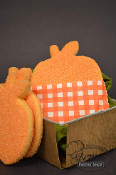 Sugar cookies in the sweet shape of a pumpkin topped with sanding sugar.