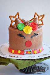 Miniature buttercream cake an adorable reindeer. Too sweet to pass up!