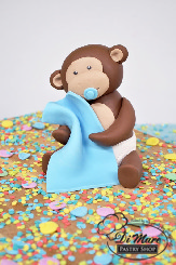 Monkey around with this two tier fondant baby shower cake, complete with fondant monkey topper