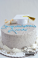 A sweet and simple graduation oreo style graduation cake with a graduation cap and graduation scroll.
