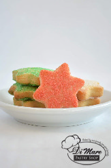 Small six-sided star butter cookies topped with sanding star.